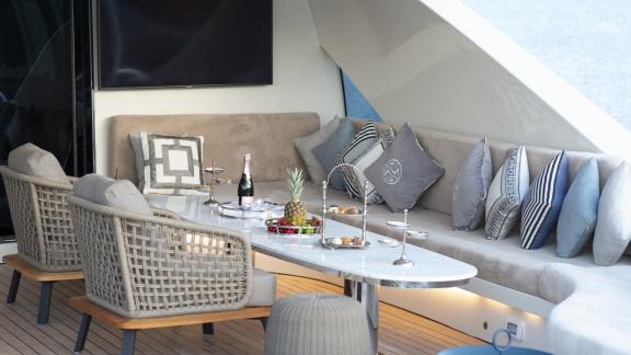 A beautifully decorated comfortable seating lounge with decorative cushions and nibbles in the outdoor area of the luxur
